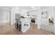 Well-designed kitchen offers open shelving, stainless appliances, white countertops and central island with seating at 1750 Wewatta St # 1301, Denver, CO 80202