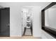 A hallway view into a laundry room featuring a stacked washer and dryer at 1750 Wewatta St # 1301, Denver, CO 80202
