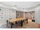 Library with extensive bookshelves, wooden table and chairs at 1750 Wewatta St # 1301, Denver, CO 80202