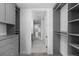 Organized walk-in closet with custom shelves and drawers, connecting to a stylish en-suite bathroom at 1750 Wewatta St # 1301, Denver, CO 80202