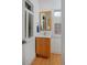 Bathroom features a wooden vanity with white countertop, a framed mirror, and window with shutters at 2500 Locust St, Denver, CO 80207