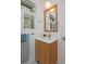 Bathroom featuring a wood vanity with white countertop and fixtures at 2500 Locust St, Denver, CO 80207