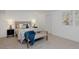 Well-lit bedroom with neutral decor, cozy bedding, and a decorative throw at 2500 Locust St, Denver, CO 80207