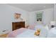Bright bedroom featuring two twin beds, hardwood floors, and a colorful accent wall at 2500 Locust St, Denver, CO 80207