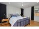 Bedroom with black-out curtains, ceiling fan, and black metal bed frame with side tables at 2500 Locust St, Denver, CO 80207