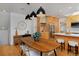 Chic dining area with wooden table, modern lighting, and kitchen access at 2500 Locust St, Denver, CO 80207