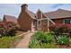 A brick home featuring a stone walkway and lush landscaping at 2500 Locust St, Denver, CO 80207