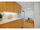 Hallway features light wood floors, white walls and built-in bench with storage and coat rack at 2500 Locust St, Denver, CO 80207