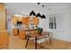 Modern kitchen and dining area with wooden cabinets and stylish lighting at 2500 Locust St, Denver, CO 80207