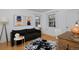 Inviting home office area with black sofa, decorative rug and warm lighting at 2500 Locust St, Denver, CO 80207