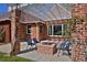 Covered outdoor patio with chairs, brick pillars, string lights and beautiful plants at 2500 Locust St, Denver, CO 80207