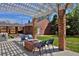 Backyard covered patio with chairs, a brick fire pit, and view of the yard at 2500 Locust St, Denver, CO 80207
