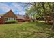 Expansive front yard with mature trees and manicured landscaping at 2500 Locust St, Denver, CO 80207