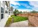 Beautiful green lawn enclosed by a brick privacy wall, perfect for outdoor enjoyment and relaxation at 3802 Lee Cir, Wheat Ridge, CO 80033