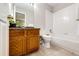 Bright bathroom with a granite-topped wood vanity and a separate tub and shower, offering functionality and style at 3802 Lee Cir, Wheat Ridge, CO 80033