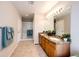 Bathroom featuring a double vanity, granite countertops, walk-in shower, and towel racks at 3802 Lee Cir, Wheat Ridge, CO 80033