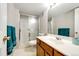 Clean bathroom featuring a sink with white countertop, a glass-enclosed shower, providing a refreshing and functional space at 3802 Lee Cir, Wheat Ridge, CO 80033