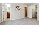 Spacious bedroom featuring soft carpeting and doors to the bathroom and closet providing ample space and convenience at 3802 Lee Cir, Wheat Ridge, CO 80033