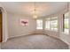Bright dining room with large windows, neutral carpet, and elegant chandelier at 3802 Lee Cir, Wheat Ridge, CO 80033