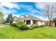Charming one-story home featuring a well-manicured lawn, brick accents, and a welcoming front porch at 3802 Lee Cir, Wheat Ridge, CO 80033