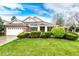 Charming one-story home with brick accents, manicured lawn and mature landscaping under a bright blue sky at 3802 Lee Cir, Wheat Ridge, CO 80033