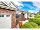 A cozy brick home entrance featuring manicured landscaping and a warm, inviting front porch area at 3802 Lee Cir, Wheat Ridge, CO 80033