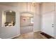 Welcoming foyer featuring tile floors, arched doorway, and a charming display nook with a decorative mirror at 3802 Lee Cir, Wheat Ridge, CO 80033