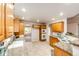 Well-lit kitchen showcasing wood cabinetry, stone countertops, and modern appliances at 3802 Lee Cir, Wheat Ridge, CO 80033