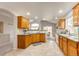 Spacious kitchen with abundant counter space, wood cabinets, and views to the backyard at 3802 Lee Cir, Wheat Ridge, CO 80033