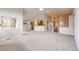 Expansive living area featuring vaulted ceilings, neutral carpet, and adjacent kitchen at 3802 Lee Cir, Wheat Ridge, CO 80033