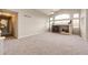 Spacious carpeted living room featuring a fireplace, vaulted ceiling, and large windows for natural light at 3802 Lee Cir, Wheat Ridge, CO 80033