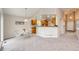 Open-concept living room with a dining nook, kitchen, and view of the front door at 3802 Lee Cir, Wheat Ridge, CO 80033