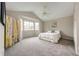 Well-lit main bedroom featuring vaulted ceilings, bay windows, and a plush carpet at 3802 Lee Cir, Wheat Ridge, CO 80033