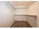 Spacious walk-in closet featuring a carpeted floor, white walls, and metal racks at 3802 Lee Cir, Wheat Ridge, CO 80033