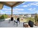 Covered back patio with seating area and a view of the surrounding neighborhood at 3280 Youngheart Way, Castle Rock, CO 80109