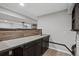 Basement wet bar with wood-look laminate and a metal countertop at 3280 Young Heart Way, Castle Rock, CO 80109