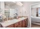 Double vanity bathroom with shower and view of bedroom at 3280 Youngheart Way, Castle Rock, CO 80109