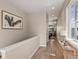 Bright hallway with hardwood floors, neutral walls, and access to other rooms at 3280 Young Heart Way, Castle Rock, CO 80109