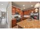 Modern kitchen with wood cabinets, granite counters, and stainless steel appliances at 3280 Youngheart Way, Castle Rock, CO 80109