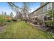 Green backyard with a hot tub, outdoor seating, and patio area at 9251 Sand Hill Trl, Highlands Ranch, CO 80126