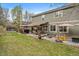 Well-maintained backyard with a patio area, seating, and a lush green lawn at 9251 Sand Hill Trl, Highlands Ranch, CO 80126