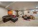 Basement living room area with dark brown furniture, and a fireplace with a wood burning stove at 9251 Sand Hill Trl, Highlands Ranch, CO 80126