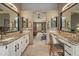 Bathroom with double vanities and a view of the bedroom that includes exercise equipment at 9251 Sand Hill Trl, Highlands Ranch, CO 80126