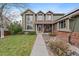 Charming home with a welcoming entrance, lovely garden area, and well-manicured lawn at 9251 Sand Hill Trl, Highlands Ranch, CO 80126