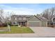 Charming two-story home with a three-car garage, solar panels, and well-maintained lawn at 9251 Sand Hill Trl, Highlands Ranch, CO 80126