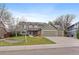 Inviting two-story home with a three-car garage, well-maintained lawn, and solar panels at 9251 Sand Hill Trl, Highlands Ranch, CO 80126