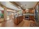 Spacious kitchen featuring wood cabinets, granite counters, central island, and stainless steel appliances at 9251 Sand Hill Trl, Highlands Ranch, CO 80126