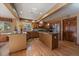 Well-appointed kitchen with granite countertops, island, stainless steel appliances, and hardwood floors at 9251 Sand Hill Trl, Highlands Ranch, CO 80126