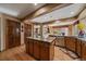 Eat-in kitchen boasts stainless appliances, granite countertops, an island, wood floors, and wood cabinets at 9251 Sand Hill Trl, Highlands Ranch, CO 80126