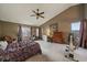 Bright primary bedroom with vaulted ceiling, exercise equipment and large window at 9251 Sand Hill Trl, Highlands Ranch, CO 80126